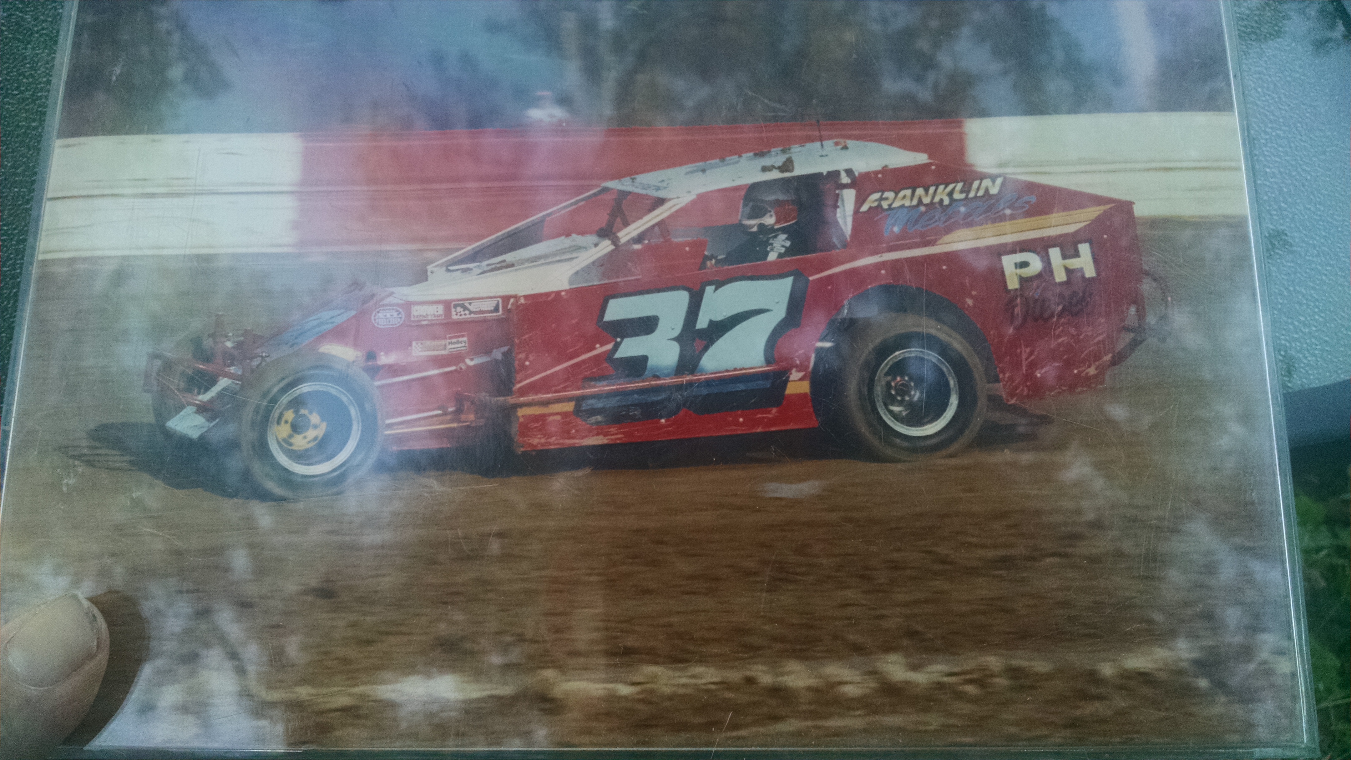 This is a picture of my dad's race car. It is a dirt track race car and number 37.